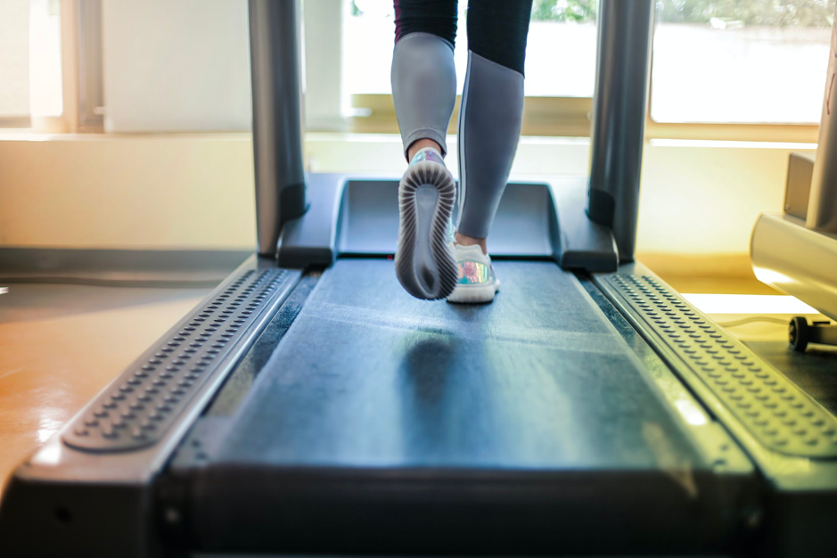 a woman running on a treadmill
