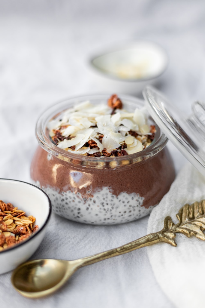 a chia pudding with some chocolate, milk, almonds, and coconut shavings on top