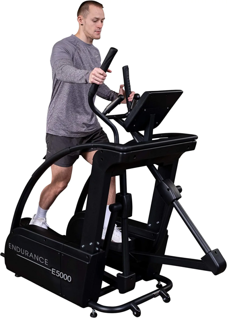 a person wearing a grey shirt while working on the elliptical machine