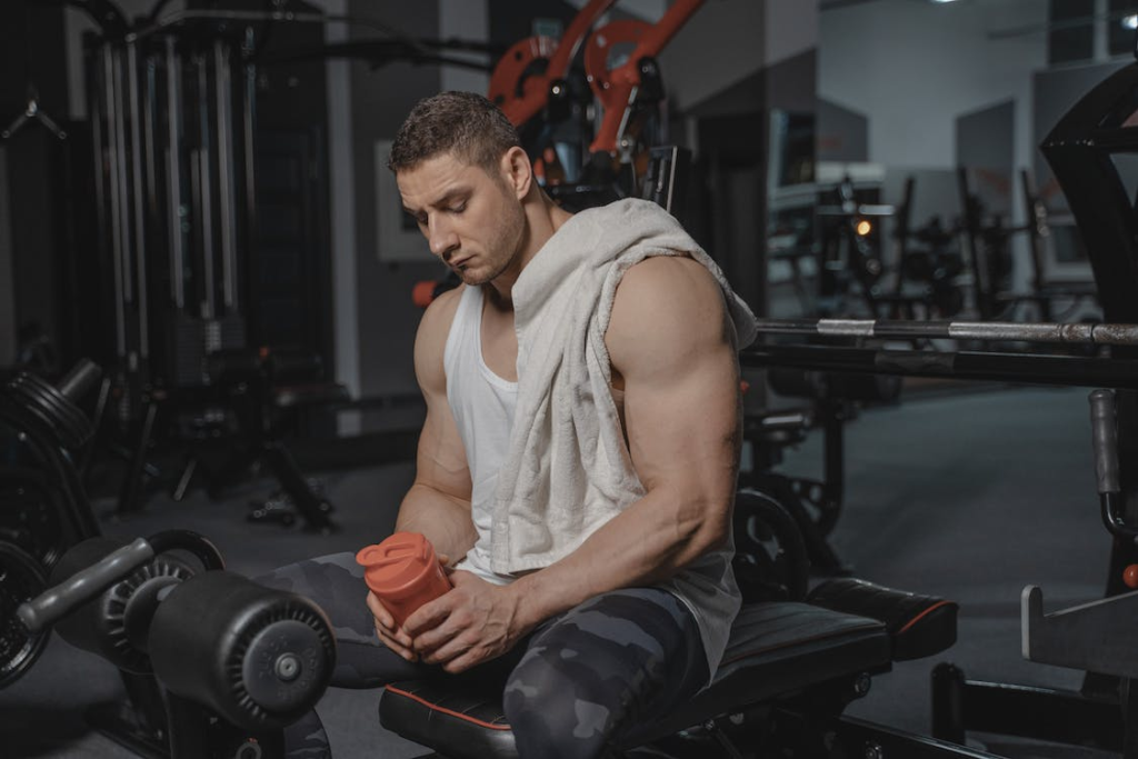 An image of a man in the gym holding a shaker