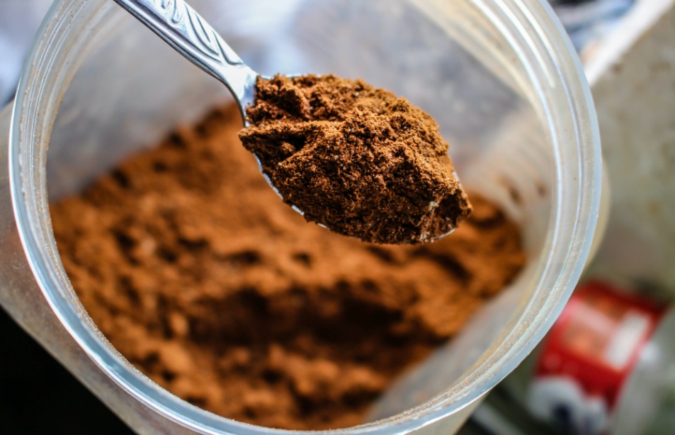 Closeup of a brown powder in a transparent jar